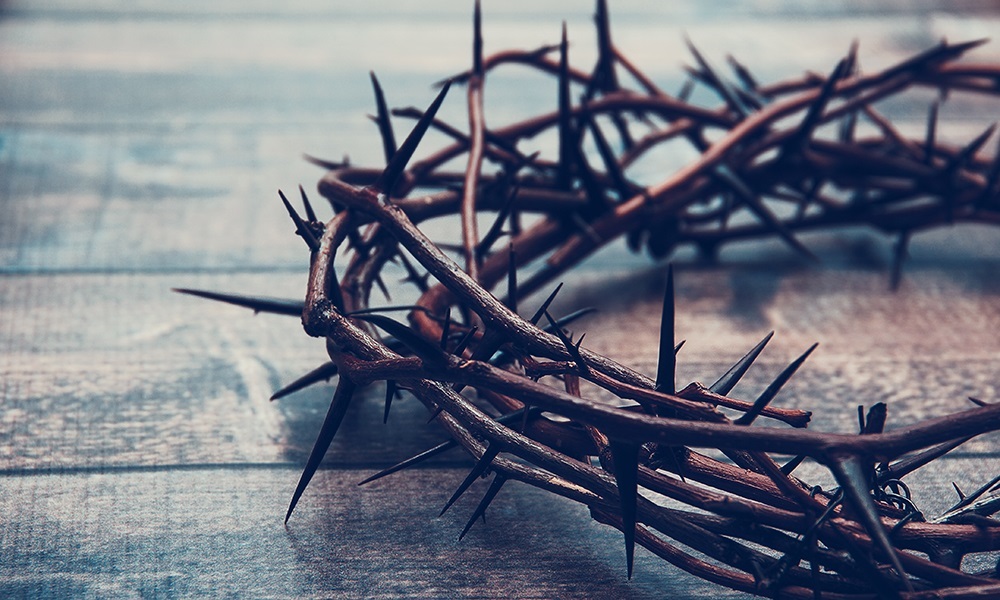 A crown of thorns resting on a wooden surface.